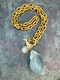 pale blue, acrylic shell with gold fish and agate charm on gold link chain, front toggle closure